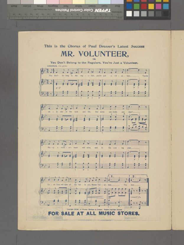 Ein aufgeschlagenes Buch mit den Worten 'Mr. Volunteer' und Musiksymbolen, mit einem Farbschema aus blauen, grünen, gelben und roten Nuancen oben.