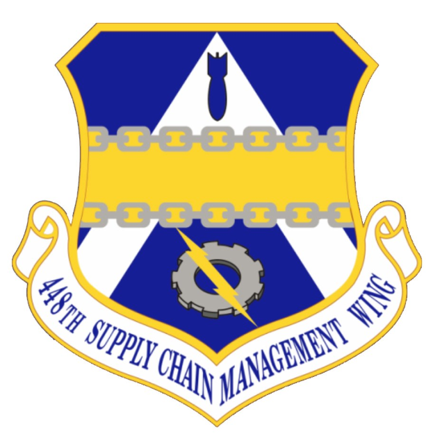 Logo des 48. Versorgungsgeschwader mit einem blauen Schild, einem weißen Stern und einem weißen Banner mit der Aufschrift "Versorgungsgeschwader" in blau, alles von einem weißen Rand und schwarzem Text darunter umgeben.